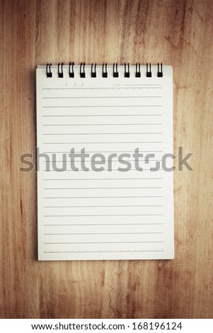 Paper page notebook. textured isolated on the wood backgrounds.