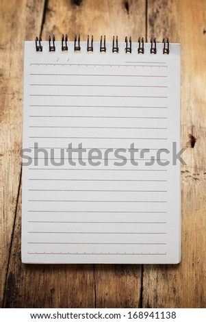 Paper page notebook. textured isolated on the wood backgrounds.