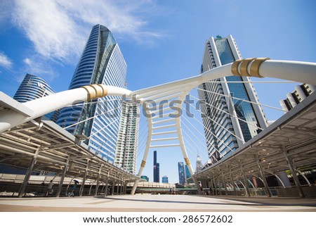 BANGKOK -JUNE 11: View of high buildings and public sky walk for transit between Sky Transit and Bus Rapid Transit Systems at Sathorn-Narathiwas junction on June 11, 2015 in Bangkok, Thailand.