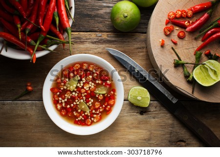 Thai fish Sauce in a cup on wood background