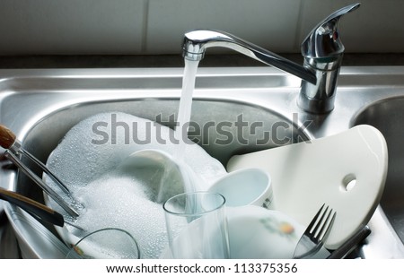 Washing kitchen ware on the sink