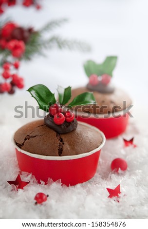 Christmas cake with holly leaves and berries on a table