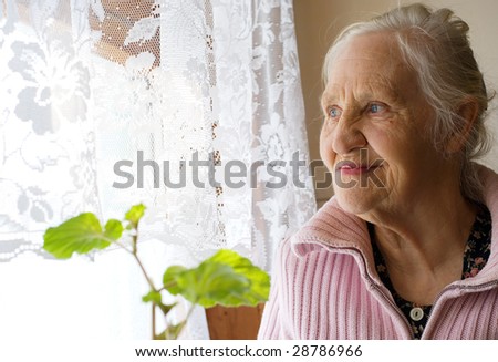 Lovely grandmother looking in the window