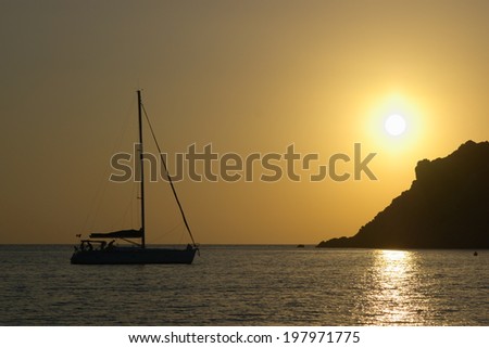 Sunset with yacht docked in sea shore