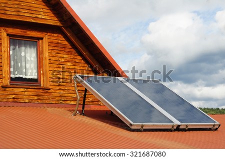 house with solar panels in summer and wood heating in winter