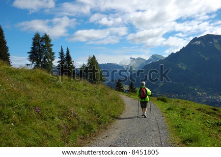 Woman hiking an alpine trail in the Swiss Bernese-Oberland