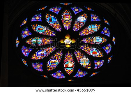 Stained glass rose window depicting bible stories.