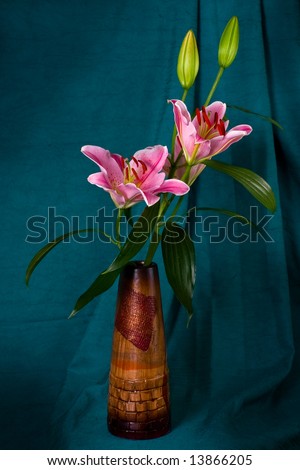bouquet lily in wooden vase draped by fabrics