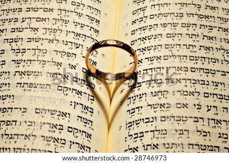 stock photo Wedding ring gives the shadow of the heart in the Bible open 