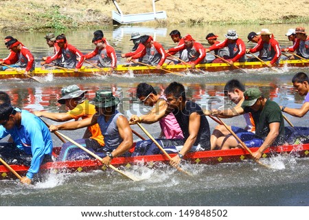 PRATUMTHANI, THAILAND - OCT 28: Top view of two rowing teams in full speed during Thai Long-tail Boat Competition for Royal Championship Cup on October 28, 2012 in Rangsit, Prathumthani,Thailand.