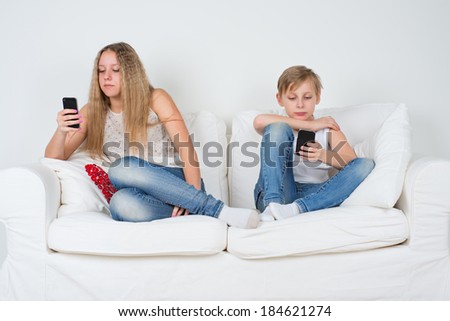 Boy and girl sitting on the couch with your phone