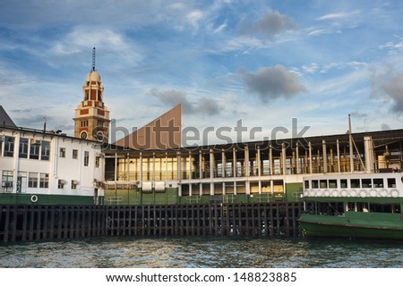 The Pier of Star Ferry and clock tower in Hong Kong under sunset