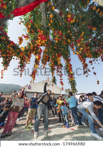 ONG KONG , CHINA - FEB. 02 : Lam Tsuen wishing tree on Feb. 02 , 2014 in Hong Kong. Tourists wrote wishes on joss paper, tied to an orange, then threw them up to hang in to make wish come true.