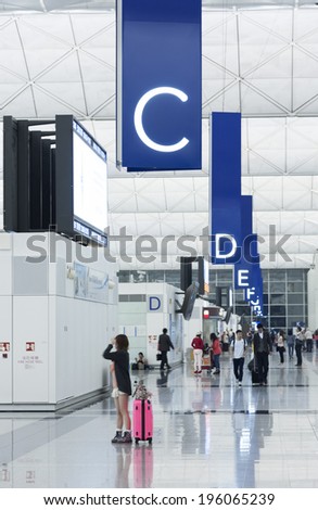 HONG KONG, CHINA - MAY 4 : Passengers in the airport main lobby on May 4, 2014 in Hong Kong, China. The Hong Kong airport handles more than 70 million passengers per year.