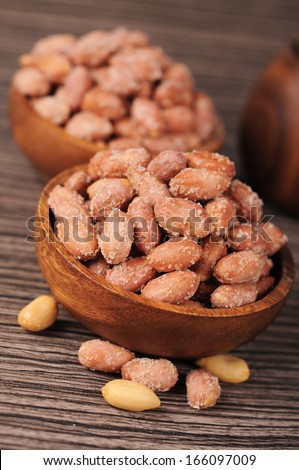 salted roasted peanuts in wooden bowl
