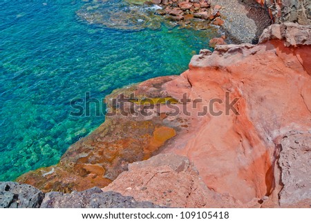 Red rocks by the ocean, viewed from above
