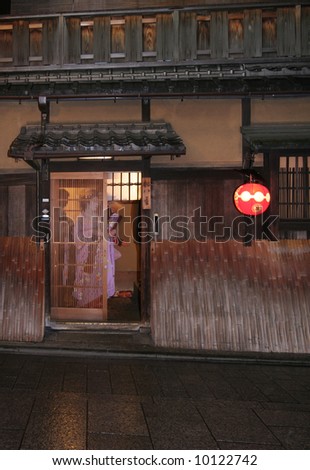 Geisha behind door with clients, Kyoto, Japan