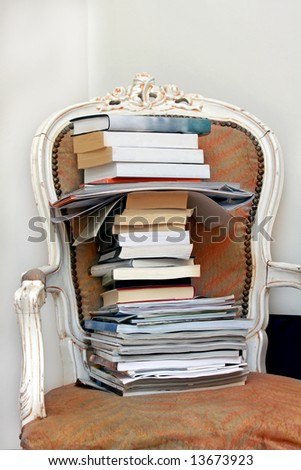 Stack of books on vintage chair