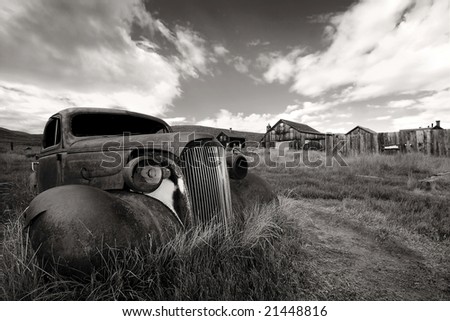 Old yellow rusted car close-up