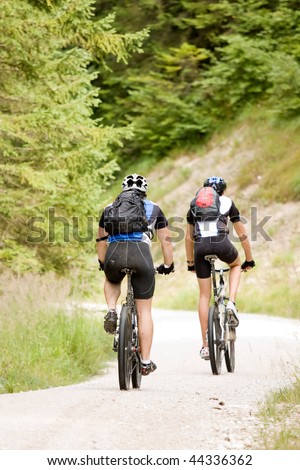 Two people riding their mountain bikes