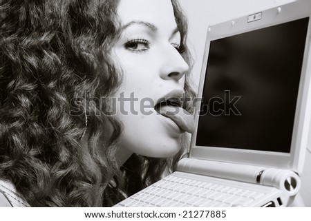 I\'ll eat you!!! Woman licking laptop.