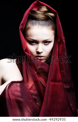 head scarf fashion. stock photo : beautiful girl enveloped in red headscarf. Fashion photo