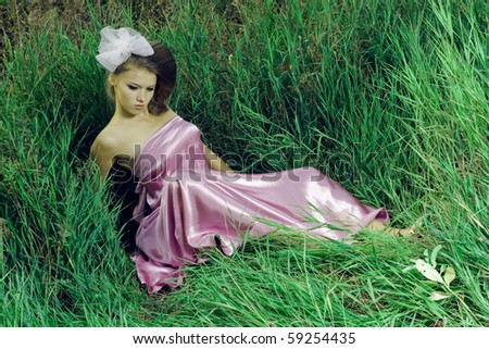 beautiful blond girl in a silk dress