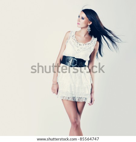 Beautiful brunette woman with elegant white dress. Fashion photo