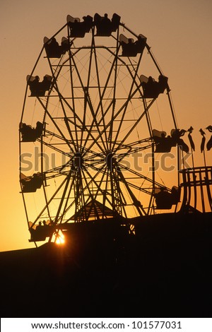 Ferris wheel silhouetted at sunset on the Santa Monica Pier in Los Angeles, CA
