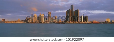 This is the Detroit skyline at sunrise. It shows the Detroit River in the foreground.
