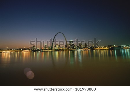 St. Louis at night, reflecting on water