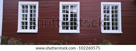 Panorama of windows on a red wall