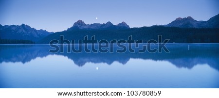 Moonset at sunrise over Redfish Lake and Sawtooth Mountains, Idaho