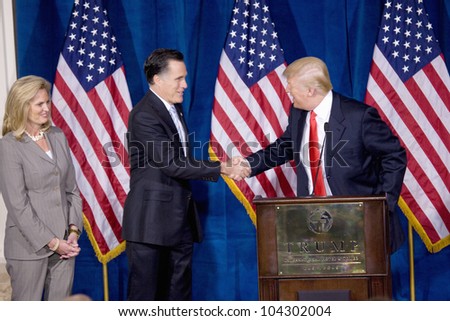 LAS VEGAS - FEB 2: Mitt Romney (C) shakes hands with Donald Trump as his wife, Ann Romney, watches at the Trump Hotel on February 2, 2012 in Las Vegas, Nevada. Trump is endorsing Romney for president.