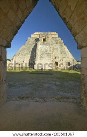Pyramid of the Magician through archway door, a Mayan ruin in the Yucatan Peninsula, Mexico at sunset
