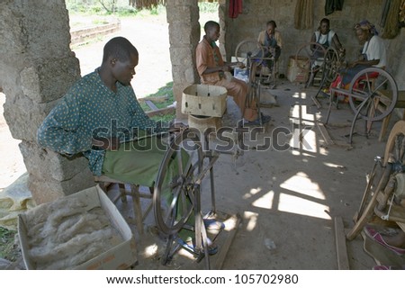 JANUARY 2007 - Masai men and women weave rugs as part of a community based business at the Lewa Foundation in North Kenya, Africa.