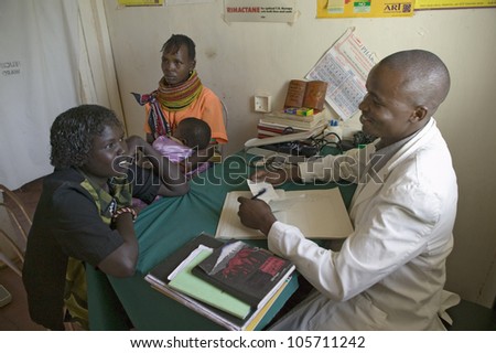 JANUARY 2007 - A doctor consults with mother and children about HIV/AIDS at Pepo La Tumaini Jangwani, HIV/AIDS Community Rehabilitation Program, Orphanage & Clinic. Nairobi, Kenya, Africa