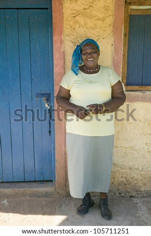 JANUARY 2007 - A Kenyan woman smiles in front of Pepo La Tumaini Jangwani, HIV/AIDS Community Rehabilitation Program, Orphanage & Clinic.  Nairobi, Kenya, Africa
