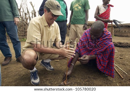 JANUARY 2005 - Humane society Chief Executive Officer, Wayne Pacelle, learning to make fire from tribesman near Tsavo National Park in Kenya, Africa