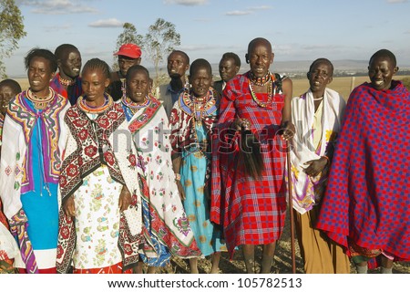 JANUARY 2005 - Village people singing at sunset in village of Nairobi National Park, Nairobi, Kenya, Africa
