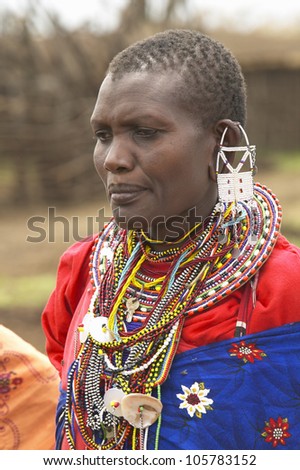 JANUARY 2005 - Masai female in robe with beads in village near Tsavo National Park, Kenya, Africa