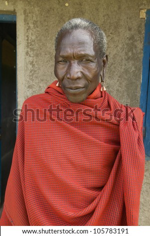 JANUARY 2005 - Masai Senior Elder man in red robe in village near Tsavo National Park, Kenya, Africa