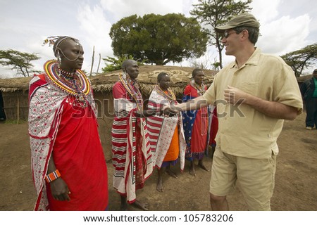 JANUARY 2005 - Wayne Pacelle CEO of Humane Society of United States meeting Masai females in robes in village near Tsavo National Park, Kenya, Africa