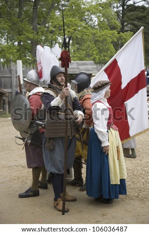 English settler reenactors holding English flag bearing the Cross of St. George as part of the 400th anniversary of the Jamestown Colony, Virginia, at James Fort, Jamestown Settlement, May 4, 2007