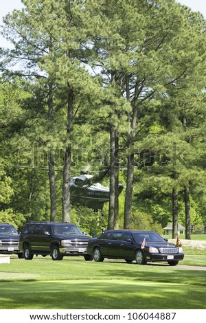 Black Presidential Limo and American Flag with motorcade of black SUV's and Marine One Helicopter lifting off from golf course in Williamsburg, Virginia on May 4, 2007.