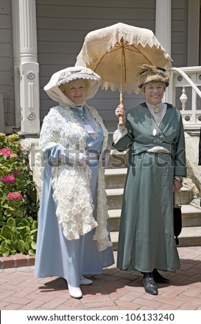 JUNE 2008 - Women in Victorian dresses standing on porch of Faulkner Farm and Victorian home in Santa Paula, CA
