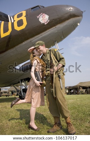 Reenactment of 1940s kiss of US soldier in front of World War II Bomber at Mid-Atlantic Air Museum World War II Weekend and Reenactment in Reading, PA held June 18, 2008