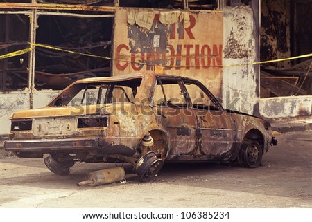 Charred car with blown-out tires and windows