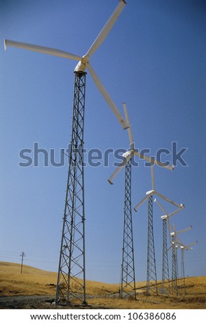 Row of horizontal-axis wind turbines standing on ground