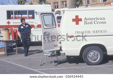 CIRCA 1990 - A Red Cross worker looking into a disaster services van during an environmental clean up
